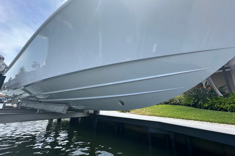 Slide: The Image of 2026 Yellowfin 39 Offshore boat hull on lift, dockside view. - 15