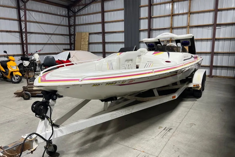Slide: The Image of 1999 Shockwave 21LS boat on trailer in a storage facility. - 3