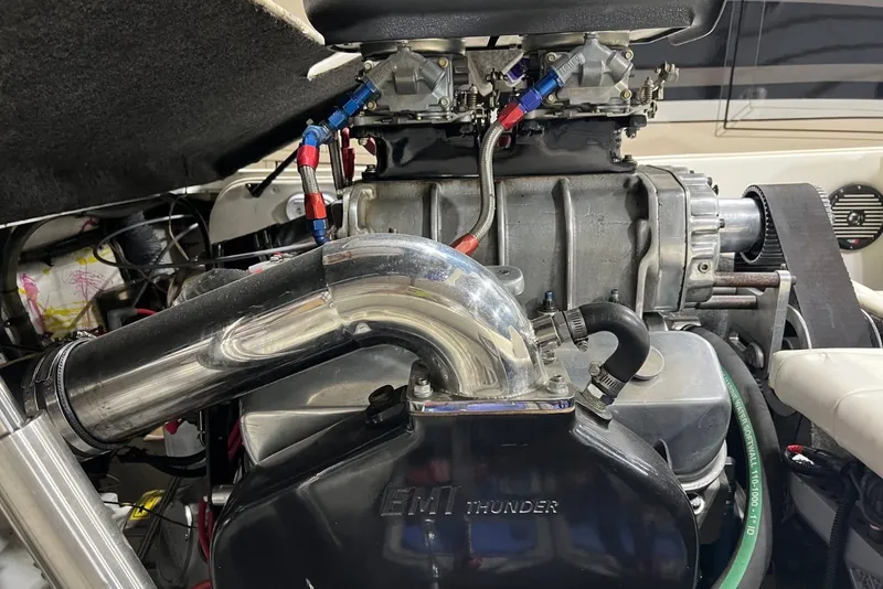 Slide: The Image of High-performance engine of a 1999 Shockwave 21LS boat, featuring EMI Thunder components. - 11