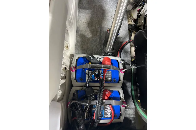 Slide: The Image of Dual marine batteries in a 1999 Shockwave 21LS boat, secured with straps. - 16