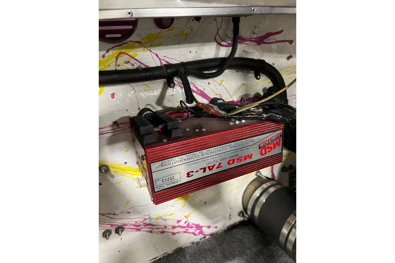 Slide: The Image of MSD Ignition system in a 1999 Shockwave 21LS boat, with colorful splatter background. - 17