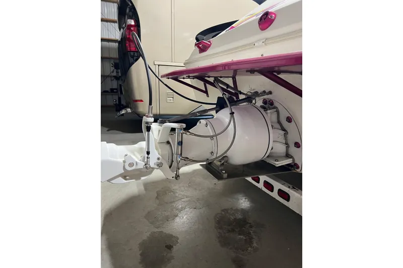 Slide: The Image of Rear view of a 1999 Shockwave 21LS boat showing the engine and propeller system. - 14