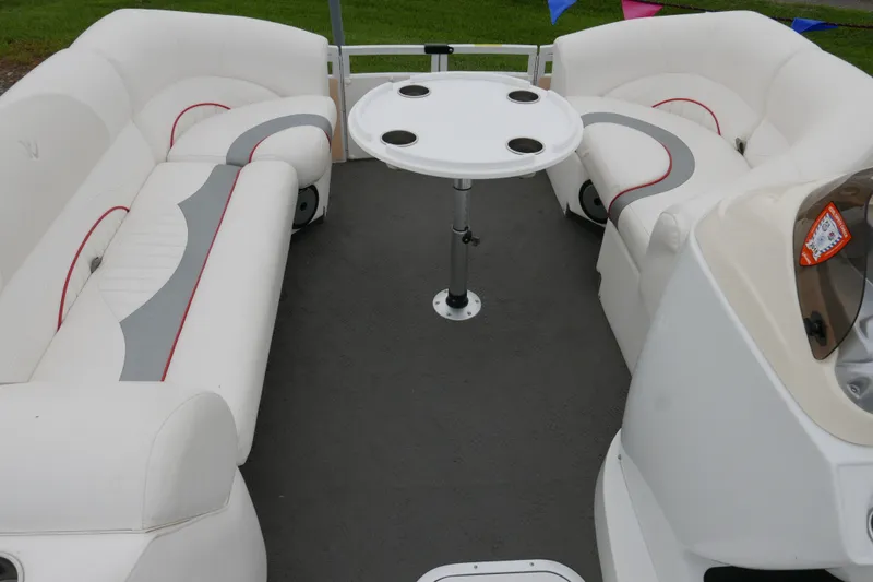 Slide: The Image of 2011 JC 23 SunLounger TT boat interior with white seating and round table. - 7