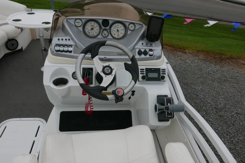 Slide: The Image of Cockpit of 2011 JC 23 SunLounger TT boat with steering wheel and control panel. - 10