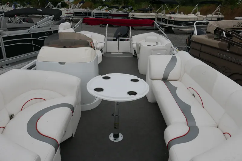 Slide: The Image of 2011 JC 23 SunLounger TT pontoon boat with spacious seating and central table. - 4