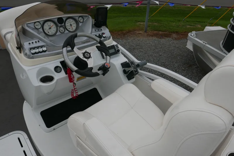 Slide: The Image of Cockpit of a 2011 JC 23 SunLounger TT boat with steering wheel and gauges. - 9
