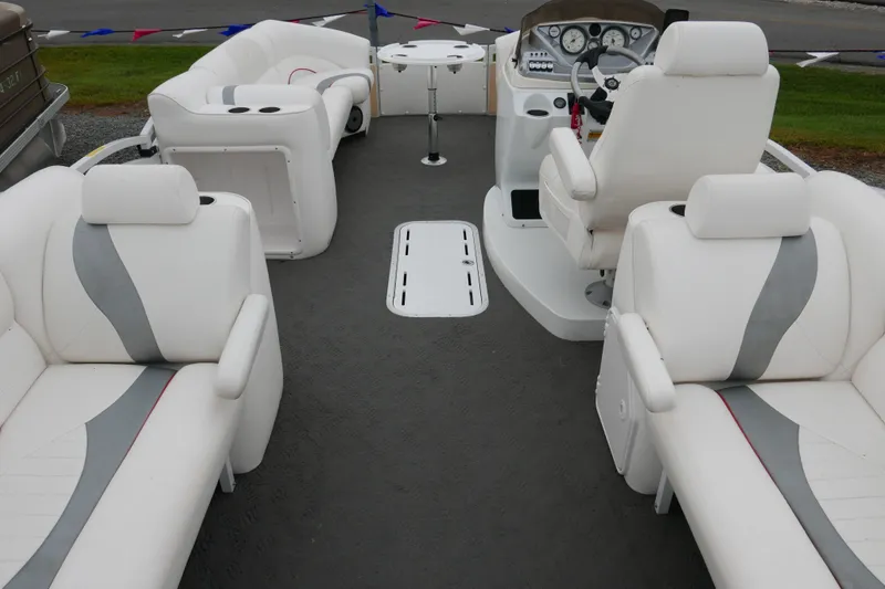 Slide: The Image of 2011 JC 23 SunLounger TT boat interior with white seating and modern dashboard. - 14