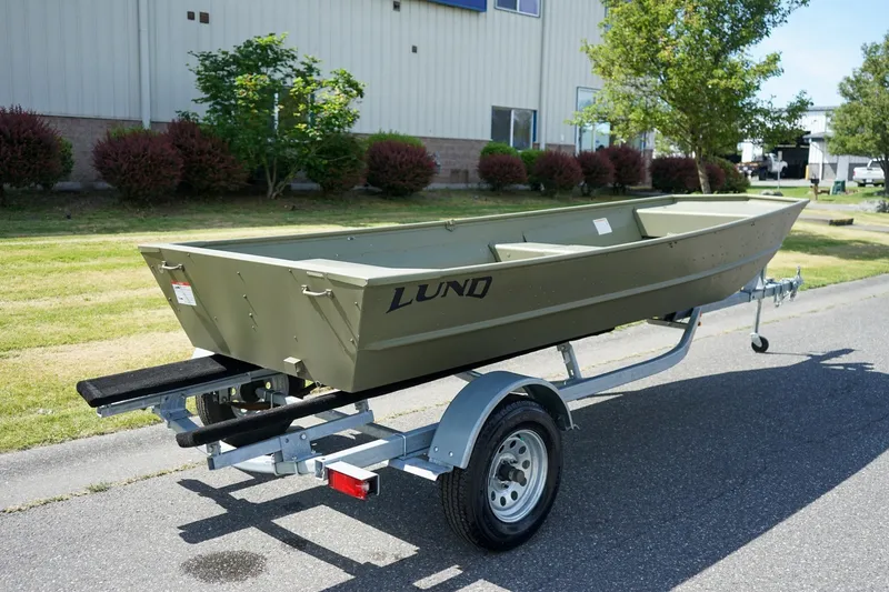 Slide: The Image of 2025 Lund 1648M boat on trailer, parked outdoors near a building. - 3