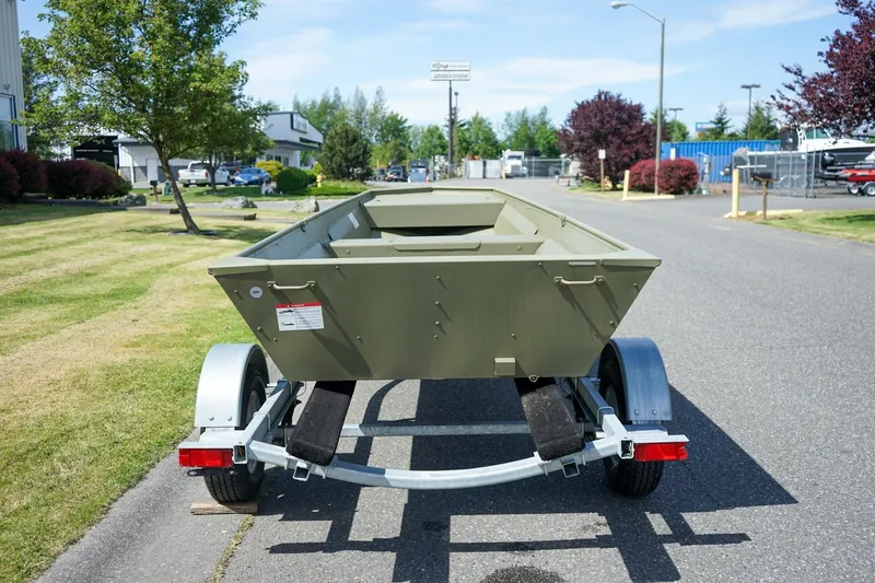 Slide: The Image of 2025 Lund 1648M boat on trailer, parked on a sunny street. - 4