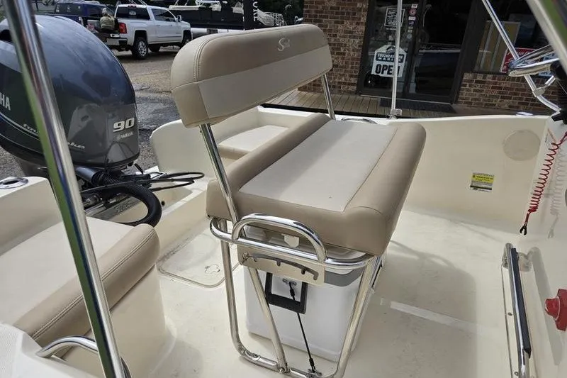 Slide: The Image of 2025 Scout 175 Sportfish boat interior with Yamaha 90 engine, featuring beige seating and storage. - 17