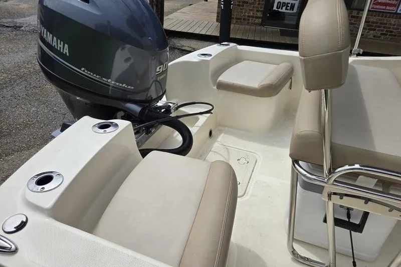 Slide: The Image of 2025 Scout 175 Sportfish boat interior with Yamaha outboard motor and beige seating. - 14