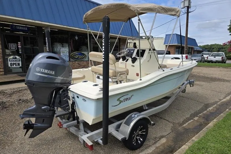 Slide: The Image of 2025 Scout 175 Sportfish boat on trailer with Yamaha outboard motor, parked outside dealership. - 7