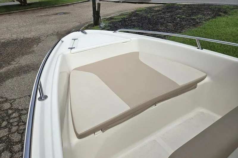 Slide: The Image of 2025 Scout 175 Sportfish boat bow with cushioned seating and stainless steel railing. - 9