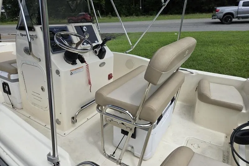 Slide: The Image of 2025 Scout 175 Sportfish boat interior with steering console and seating. - 5