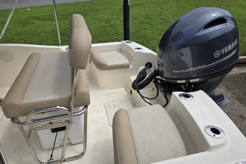 Slide: The Image of 2025 Scout 175 Sportfish boat interior with Yamaha outboard motor and beige seating. - 6