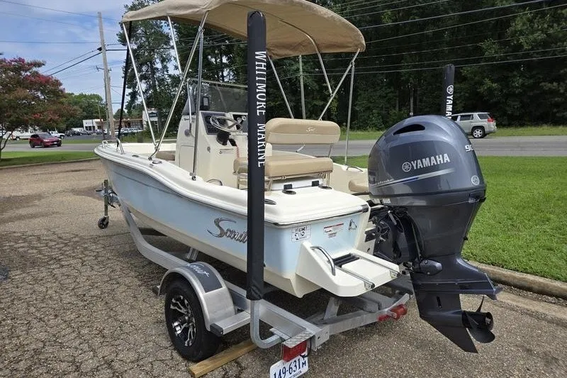 Slide: The Image of 2025 Scout 175 Sportfish boat with Yamaha engine on trailer, parked outdoors. - 10