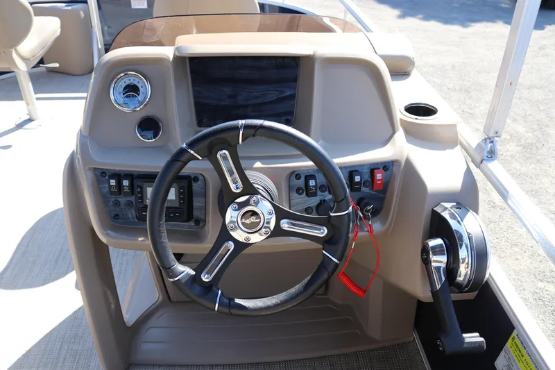 Slide: The Image of 2025 Sun Chaser Vista Fish 18 boat dashboard with steering wheel and controls. - 6