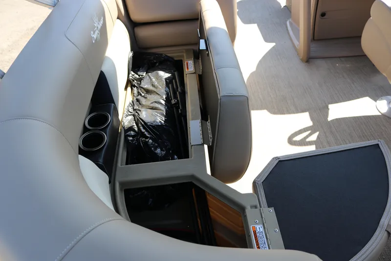 Slide: The Image of Sun Chaser Vista Fish 18 boat interior with storage compartment and cup holders, 2025 model. - 18
