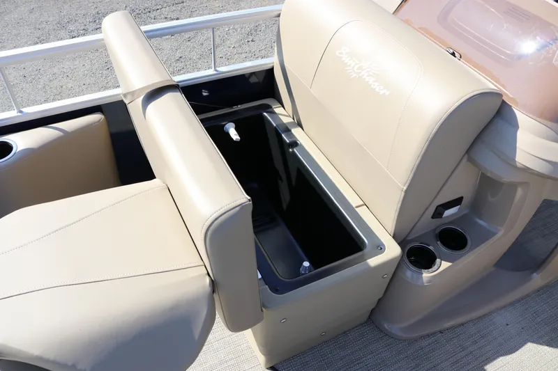 Slide: The Image of 2025 Sun Chaser Vista Fish 18 boat interior with beige seating and storage compartment. - 14