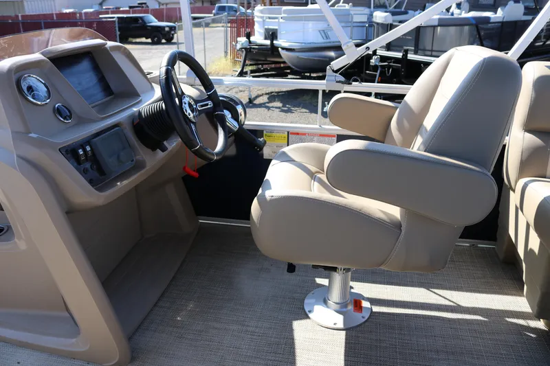 Slide: The Image of 2025 Sun Chaser Vista Fish 18 boat interior with steering wheel and captain's chair. - 5