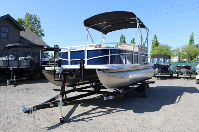Slide: The Image of 2025 Sun Chaser Vista Fish 18 pontoon boat on trailer in outdoor lot. - 4