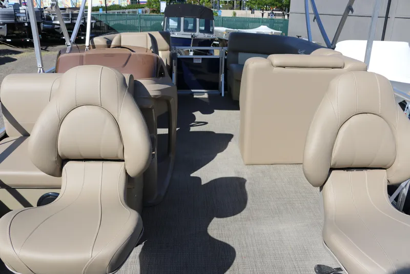 Slide: The Image of 2025 Sun Chaser Vista Fish 18 interior with beige seating and spacious layout. - 12
