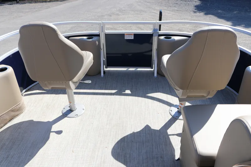Slide: The Image of 2025 Sun Chaser Vista Fish 18 boat interior with beige seating and cup holders. - 11