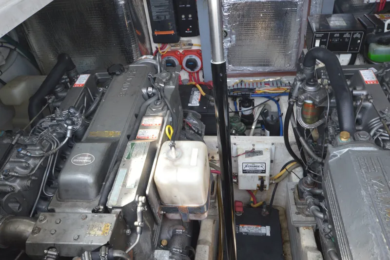 Slide: The Image of Engine room of a 2004 Luhrs 320 Open boat, showcasing dual engines and mechanical components. - 27