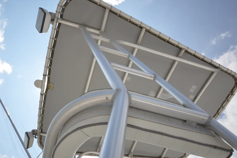 Slide: The Image of Aluminum ladder and canopy on 2004 Luhrs 320 Open boat under blue sky. - 34