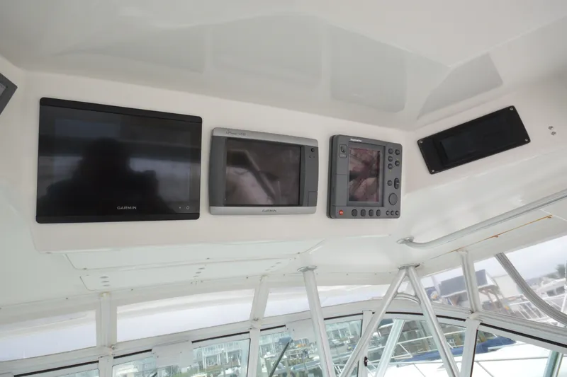 Slide: The Image of 2004 Luhrs 320 Open boat dashboard with Garmin navigation displays. - 11