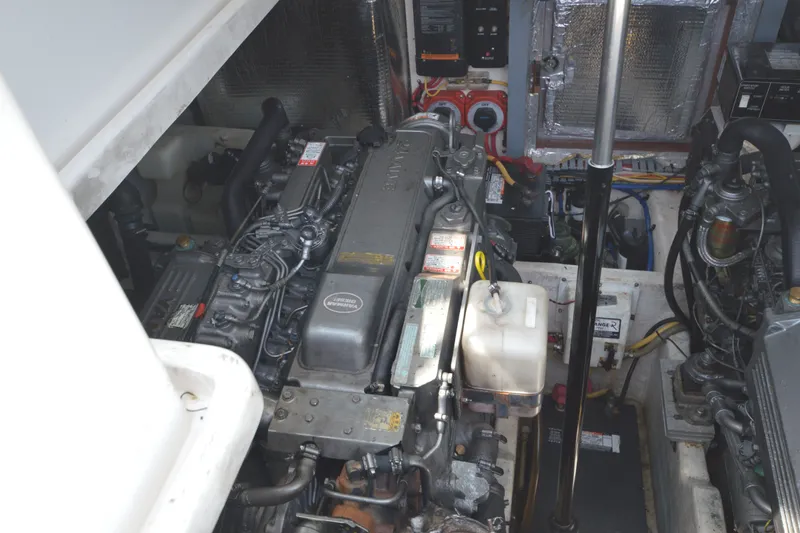 Slide: The Image of Engine compartment of a 2004 Luhrs 320 Open boat, showcasing detailed mechanical components. - 25