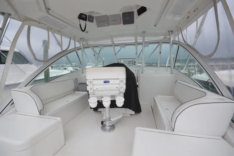 Slide: The Image of 2004 Luhrs 320 Open boat interior with white seating and helm station. - 8