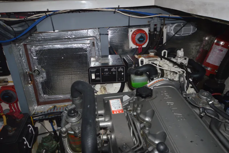 Slide: The Image of Engine room of a 2004 Luhrs 320 Open boat, showcasing mechanical components and wiring. - 29