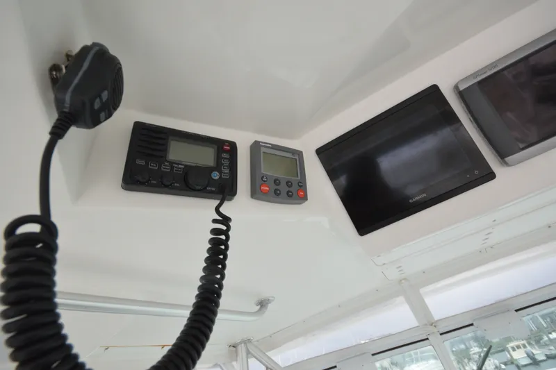 Slide: The Image of 2004 Luhrs 320 Open boat dashboard with communication and navigation equipment. - 12