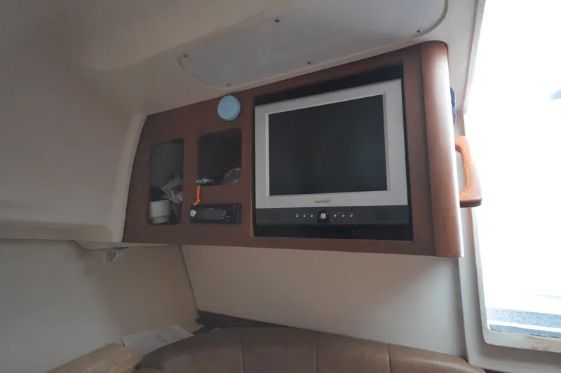 Slide: The Image of 2004 Luhrs 320 Open cabin interior with TV and storage compartments. - 16