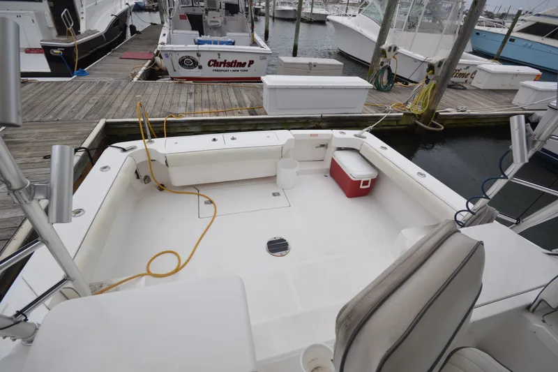Slide: The Image of 2004 Luhrs 320 Open boat docked, featuring spacious deck and seating area. - 9
