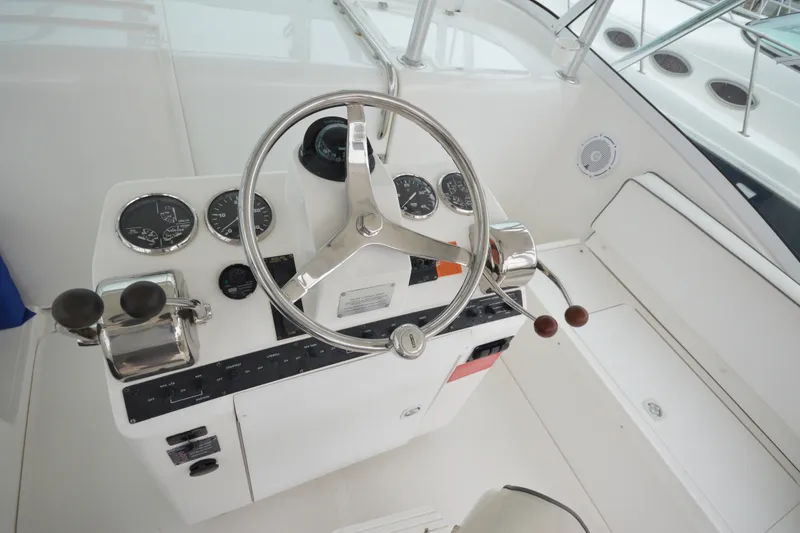 Slide: The Image of 2004 Luhrs 320 Open boat helm with steering wheel and control panel. - 14