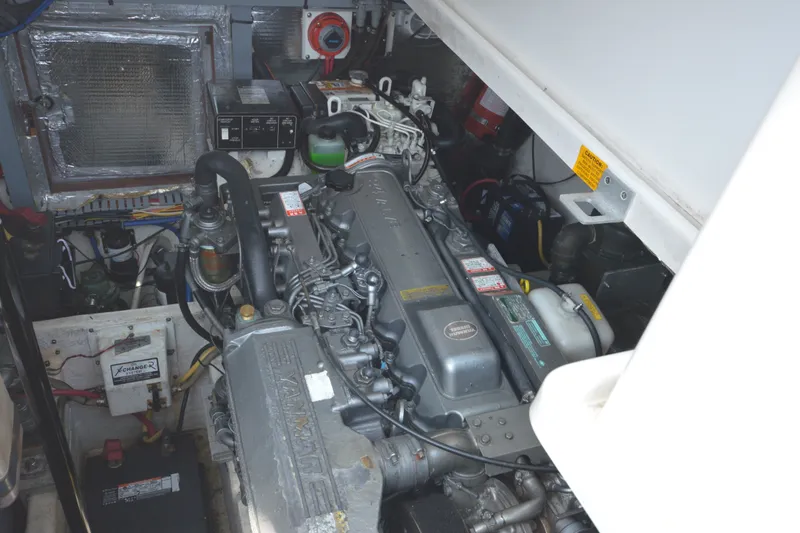 Slide: The Image of Engine compartment of a 2004 Luhrs 320 Open boat, showcasing mechanical components and wiring. - 26