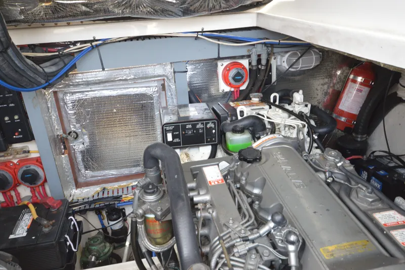 Slide: The Image of Engine room of 2004 Luhrs 320 Open boat, featuring mechanical components and safety equipment. - 28