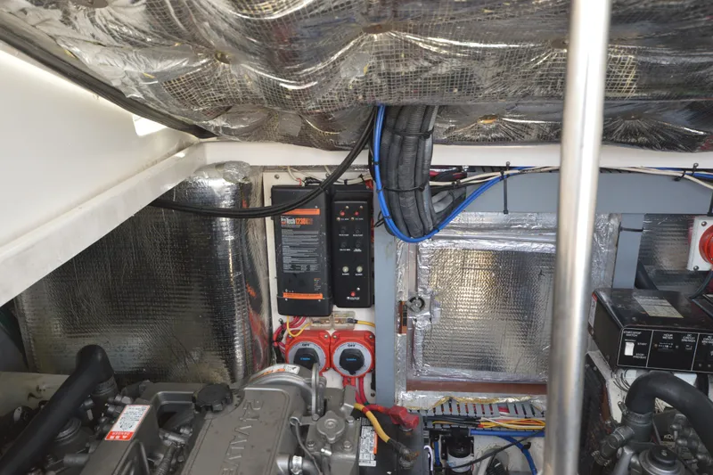 Slide: The Image of Engine room of 2004 Luhrs 320 Open boat with wiring and insulation. - 32