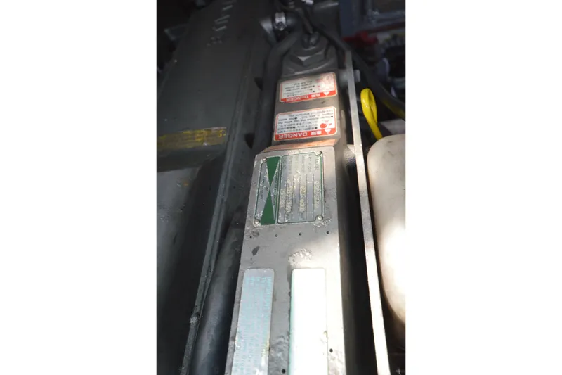 Slide: The Image of Engine compartment of 2004 Luhrs 320 Open boat with visible warning labels. - 30