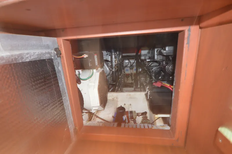 Slide: The Image of Engine compartment of 2004 Luhrs 320 Open boat, showcasing mechanical components and wiring. - 17