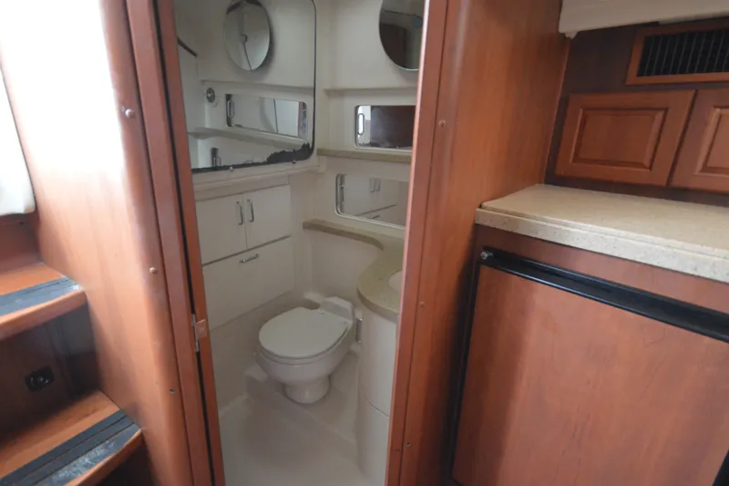 Slide: The Image of 2004 Luhrs 320 Open boat interior with bathroom and kitchenette. - 21