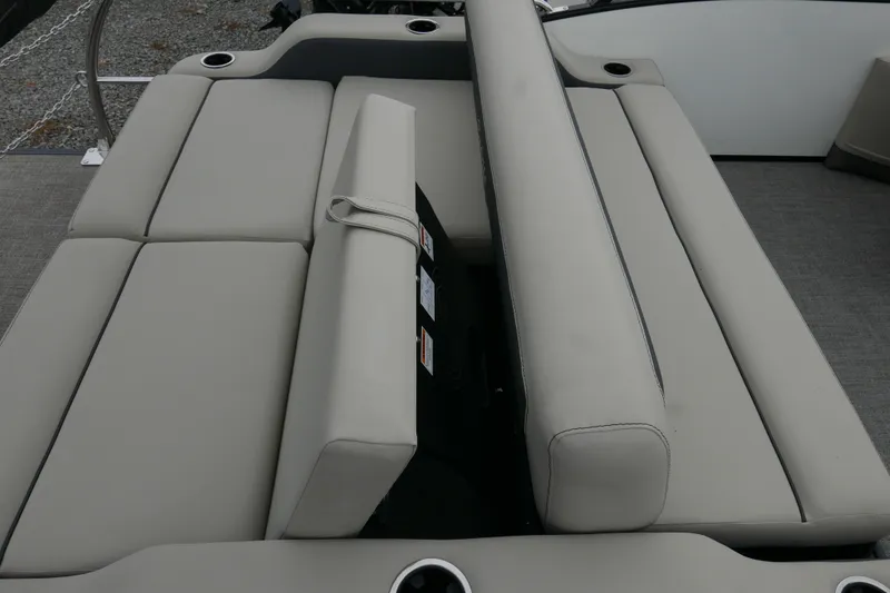 Slide: The Image of 2023 Barletta Cabrio C22UC boat interior with beige seating and cup holders. - 13