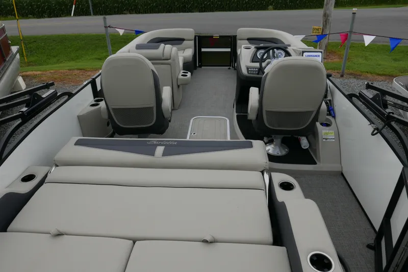Slide: The Image of 2023 Barletta Cabrio C22UC pontoon boat interior with plush seating and modern dashboard. - 16