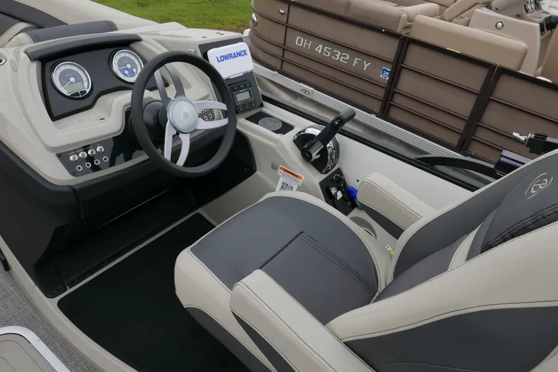 Slide: The Image of 2023 Barletta Cabrio C22UC boat interior with steering wheel and dashboard controls. - 9