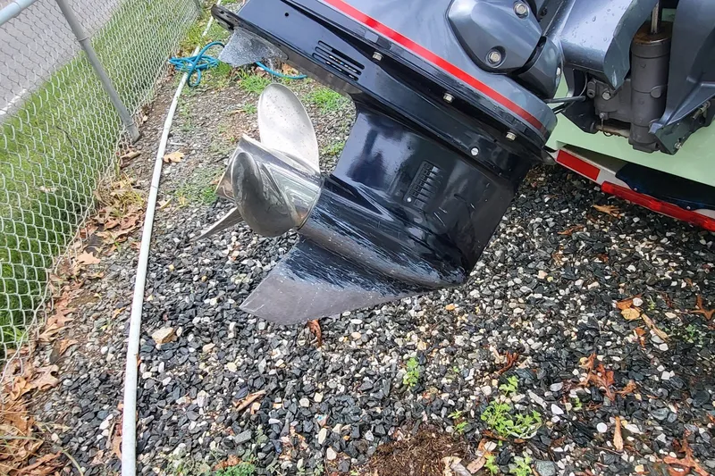 Slide: The Image of 2019 Maverick Mirage 18 HPX-V boat motor on gravel, showcasing propeller and lower unit. - 10