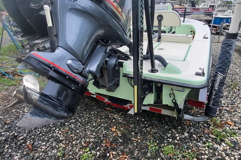 Slide: The Image of 2019 Maverick Mirage 18 HPX-V boat with outboard motor on gravel surface. - 9