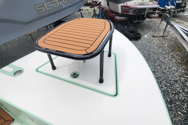 Slide: The Image of 2019 Maverick Mirage 18 HPX-V boat with a wooden platform on deck. - 13