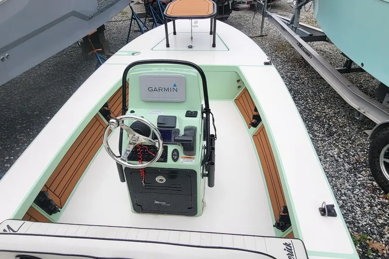 Slide: The Image of 2019 Maverick Mirage 18 HPX-V boat with Garmin navigation system, featuring sleek design and wood accents. - 17